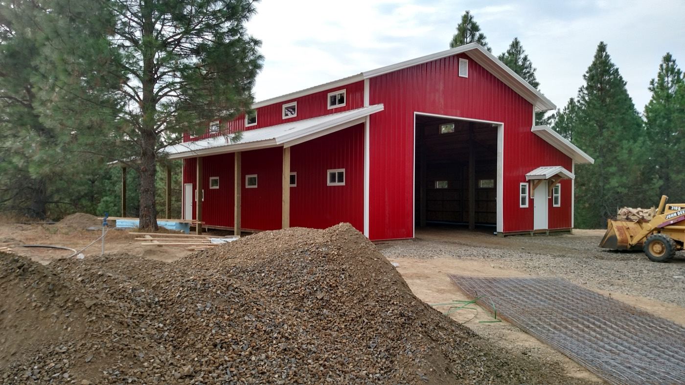 Large red pole building shop with lean-to