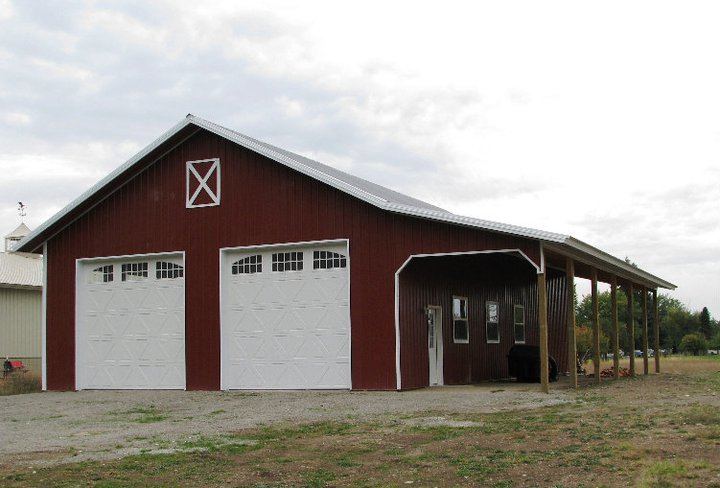 Red garage with awning and two overhead doors